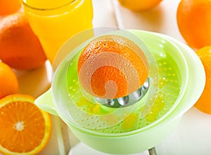 Orange squeezer with fresh fruits