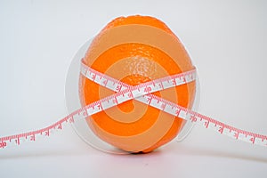 Orange standing on the table with ruler