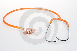 Orange stethoscope phonendoscope on a white background isolated