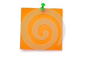 Orange sticker on green thumbtack