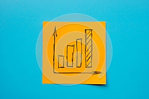 An orange sticker with a growing graph symbolizing business success, growth and increase.