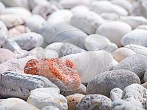 Orange stone among other stones
