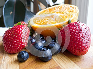 Orange Strawberry Blueberry Fruits on Wooden Cutting Board