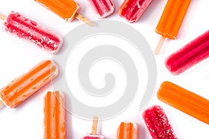 Orange and strawberry popsicles isolated on white background..
