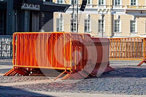 Mobile steel fence. orange street barriers to restrict movement before the concert