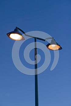Orange streetlamps against blue sky
