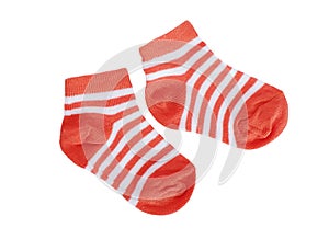 Orange striped baby socks on white background