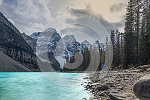 Orange sunlight through cloudy sky at Moraine lake, Banff national park