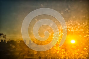 orange sunrise through a frozen window. background