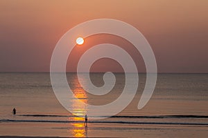 Orange Sunrise over the Atlantic Ocean with calm waves