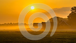 Orange sunrise over Dutch countryside