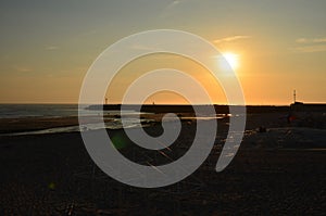 Orange sunset on the Atlantic coast in Ancora, Portugal. In the shadow hides the beach and the pier of Ancora