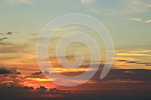 Orange sunset behind clouds