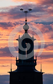 Orange sunset behind the tower of the city hall of Stockholm