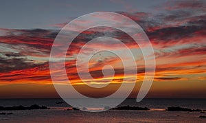 Orange sunset and cloudscape on sea