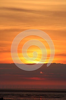 Orange sunset glow in sky over Morecambe Bay