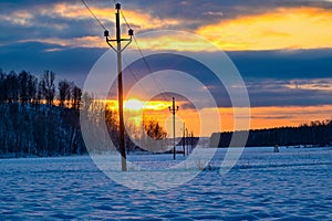 orange sunset and power line in field