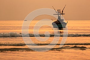 Orange sunset on the sea with boats