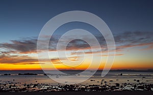 Orange sunset on sea rocky shore