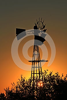 Orange Sunset with sky and the Sun and a Windmill silhouette