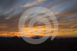 Orange sunset sky on a winter day.