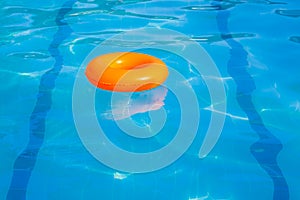 Orange swim ring in swimming pool