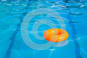 Orange swim ring in swimming pool
