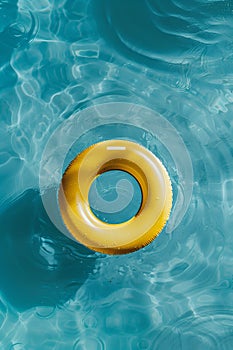 Orange swimming pool ring floating on the calm water in the swimming pool. High angle view with copy space