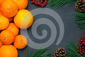 Orange and tangerine with branch christmas tree and ashberry on concrete background