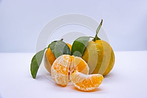 Orange Tangerine Green Citrus Fruit with leaves isolated white background