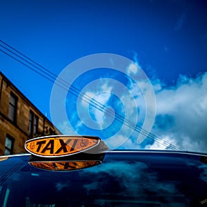 Orange Taxi Light on a Wheelchair Accessible Vehicle With Blue S