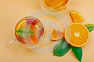 Orange tea in glass cups with ripe fruits. Refreshment seasonal drink, conceptual background