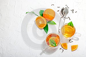 Orange tea in glass cups with ripe fruits. Refreshment seasonal drink, conceptual background