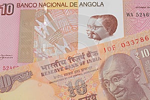 A orange ten rupee bill from India paired with a colorful ten kwanza bank note from Angola.