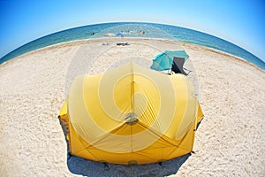 Orange tent on the beach at bright sunny day