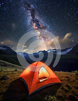 Orange tent with lights inside pitch with the sky at the Milky Way, generative AI