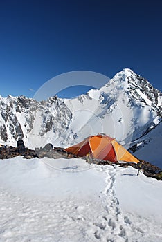 The orange tent in mountains