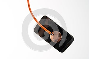 Orange thin line stethoscope With Mobile Phone Isolated On White Background concept of advice, refit, check, first aid photo