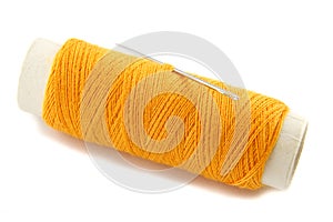 Orange thread bobbin with needle