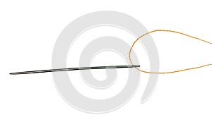 Orange thread through eye of needle