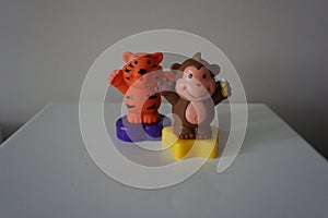 Orange tiger and brown monkey plastic toys