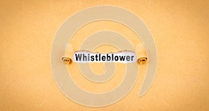 Orange Torn-up paper labeled Whistleblower