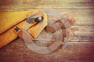 Orange towel and beach items on wood