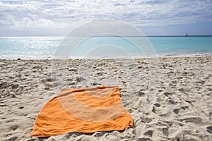 Orange towel on a tropical beach