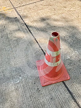 Orange traffic cone with reflective stripes