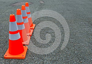 Orange traffic cones under construction asphalt road