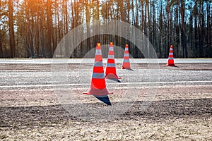 Orange traffic cones were placed on the carriageway of a suburban highway. Motorway Services Roadworks Cones. Road works, repair