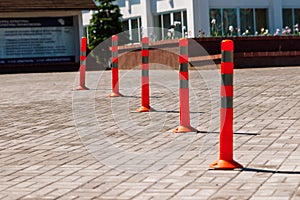 Orange traffic pillar on the road and on parking lane