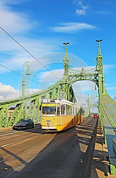 Orange tram on the Liberty bridge in Budapest, Hungary