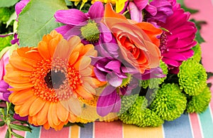 Orange Transvaal daisy and rose with colorful florist flowers.
